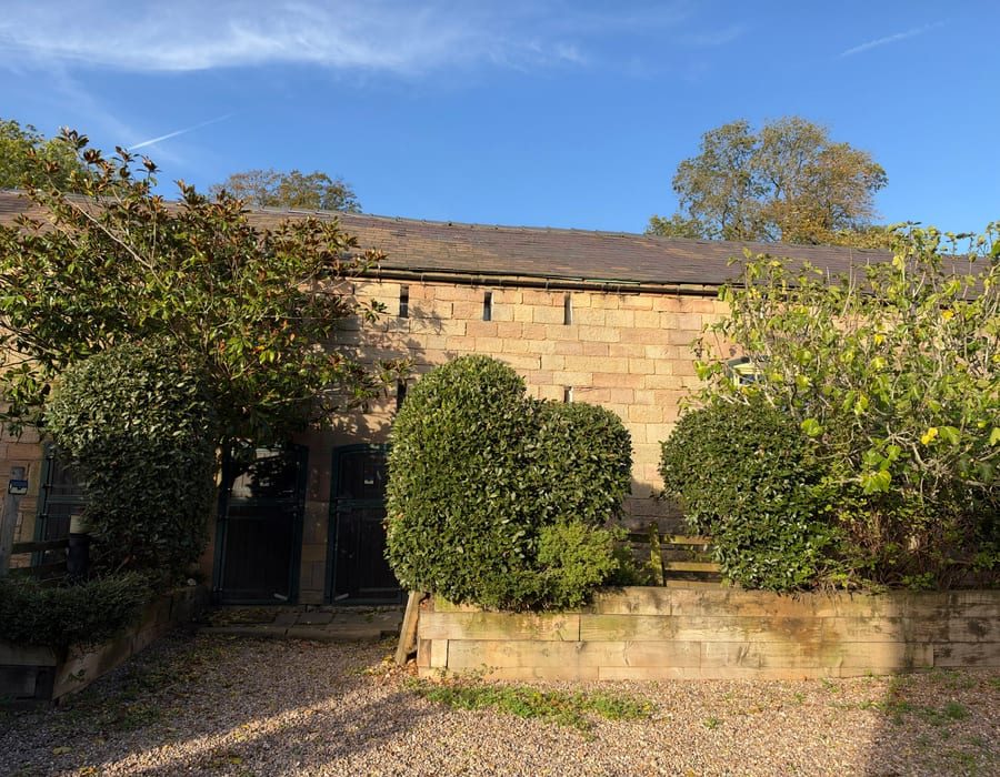 Stone cottage with ivy-covered garden walls